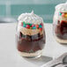 Two Acopa stemless wine glasses filled with chocolate, marshmallow, and candy desserts.