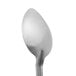 A close-up of a Vollrath stainless steel basting spoon with a white handle.