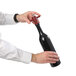 A hand using a Chef Specialties Chateau wine bottle pepper mill to open a bottle of wine.