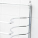 A chrome American Metalcraft pizza pan rack mounting hardware set on a wall.
