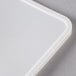 A white rectangular lid with a small rectangular cut out.