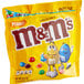 A yellow and blue bag of Peanut M&M's with a yellow cartoon character holding blue and yellow candy.