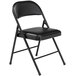 A National Public Seating black metal folding chair with a black cushioned seat.