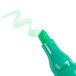 A close up of a Universal green desk style highlighter with a chisel tip.