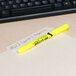 An Avery yellow Hi-Liter marker on a file folder.