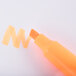 A Universal yellow chisel tip highlighter marking the word orange on a piece of paper.