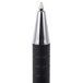 A close up of a Universal One black and silver retractable ballpoint pen tip.