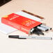 Universal UNV27410 Economy Black Medium Point 1mm Oil-Based Ballpoint Stick Pen - 12/Box Main Thumbnail 1