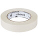 A roll of Universal beige masking tape with black text on the label.