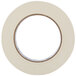 A case of Universal general purpose masking tape with a roll of white tape with a circle in the middle.