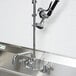 A stainless steel Equip by T&S wall mounted pre-rinse faucet with an add-on faucet and hose.