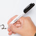 A person holding a black Universal bullet tip dry erase marker.