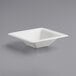 A white square EcoChoice Compostable Sugarcane bowl on a gray surface.