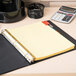 A binder with yellow Avery Big Tab dividers on a table.