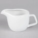 A Tuxton bright white china creamer with a handle.