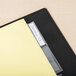 A black file folder with Avery clear tab dividers inside and a label on it.