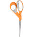 A close-up of a pair of Fiskars scissors with orange and gray Softgrip handles.
