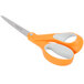 A pair of Fiskars scissors with orange and white handles.
