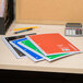A group of spiral bound Universal assorted color notebooks on a table.