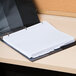 A white Universal 8-tab divider set in a binder on a desk.