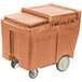 A Cambro Coffee Beige mobile ice bin with a sliding lid and wheels.