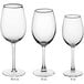 A close-up of three Acopa Select Blanc wine glasses.