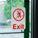 A red and white Thunder Group exit sign.