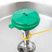 A green cap with a yellow chain on a T&S eye wash station.