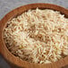 A wooden bowl filled with Royal Basmati brown rice.