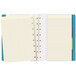 A close-up of a Filofax aqua notebook with lined pages.