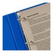 A blue binder with a white cover and a white page using a clear hole reinforcement label.