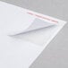 A white piece of paper with a white Universal 2" x 4" label on it.