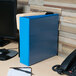 A light blue Universal Deluxe View Binder on a desk.