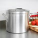 A Vollrath Wear-Ever aluminum stock pot on a counter.