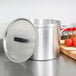 A Vollrath Wear-Ever aluminum stock pot with a lid on a counter.