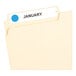 A file folder with a light blue Avery label on it.