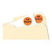 A package of Avery orange round removable labels with white dots on a sheet.