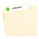 A file folder with a neon green circle label on it.