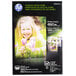 A black box of HP glossy photo paper with a young girl holding flowers on the front.