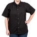 A woman wearing a black Chef Revival short sleeve cook shirt.