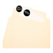A white file folder with black round labels on it.