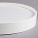 A white circular lid with a white surface and rim.