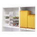 A white shelf with yellow folders and yellow Avery rectangular labels.