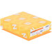 A yellow rectangular box of Astrobrights Cosmic Orange cardstock with white and yellow labels.