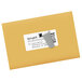 A close-up of a white Avery shipping label on a yellow mail envelope.