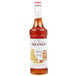 A bottle of Monin honey syrup with a white label.