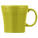 A yellow Fiesta china mug with a handle.