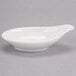 A white Royal Rideau porcelain bowl with a spoon in it.