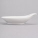 A white Royal Rideau porcelain bowl with a curved handle and a spoon on top.
