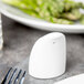 A white Royal Rideau porcelain pepper shaker on a table.